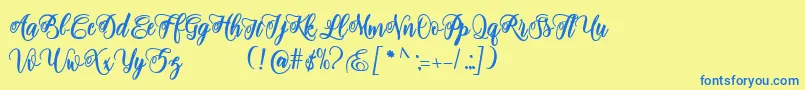 adinda script-Schriftart – Blaue Schriften auf gelbem Hintergrund