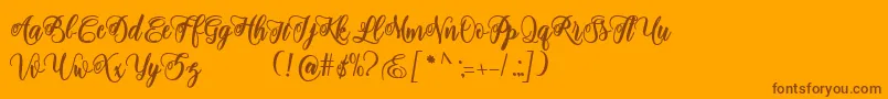Fonte adinda script – fontes marrons em um fundo laranja