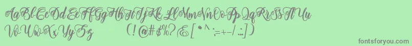 フォントadinda script – 緑の背景に灰色の文字