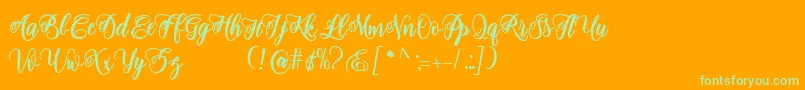 adinda script-Schriftart – Grüne Schriften auf orangefarbenem Hintergrund