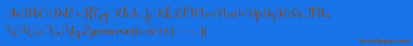 フォントAdinda – 茶色の文字が青い背景にあります。