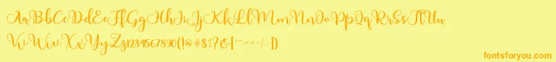 フォントAdinda – オレンジの文字が黄色の背景にあります。