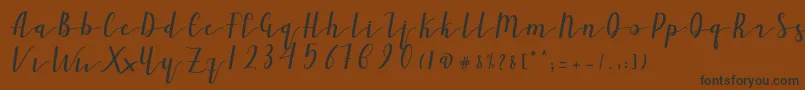 Ailand-Schriftart – Schwarze Schriften auf braunem Hintergrund