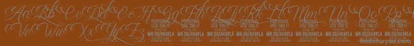 AkaylaScriptDeco PERSONAL Font – Gray Fonts on Brown Background