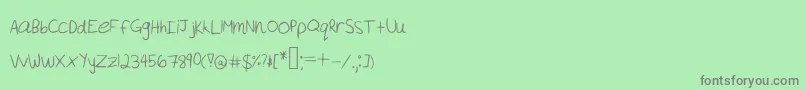 Fonte Akeylah  s Handwriting – fontes cinzas em um fundo verde