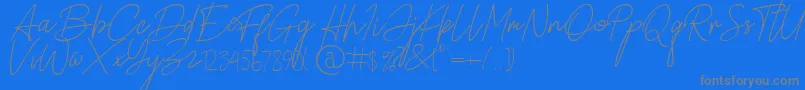 Alamanda Santika Signature-Schriftart – Graue Schriften auf blauem Hintergrund