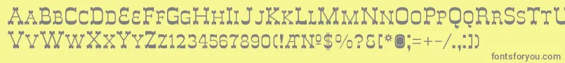DeLouisvilleSmallcaps-fontti – harmaat kirjasimet keltaisella taustalla