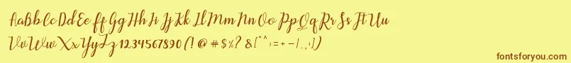 フォントAleria Script – 茶色の文字が黄色の背景にあります。