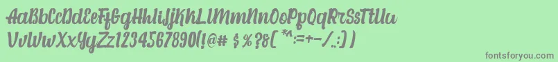 Fonte Alexandria Script – fontes cinzas em um fundo verde