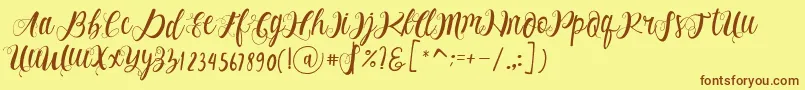 フォントAlhenya Script – 茶色の文字が黄色の背景にあります。