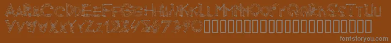 AlphaMusicMan Font – Gray Fonts on Brown Background