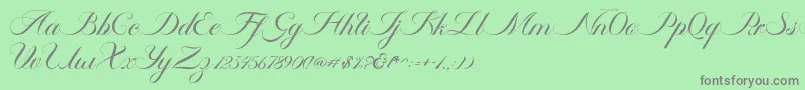 Fonte Ambergris Script Free Personal – fontes cinzas em um fundo verde