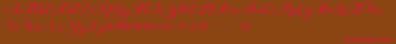 フォントAmotim – 赤い文字が茶色の背景にあります。