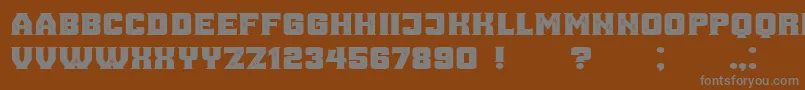 AnaGrunged Font – Gray Fonts on Brown Background