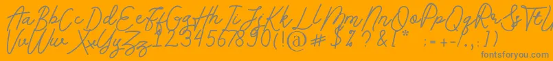 Andalusia-Schriftart – Graue Schriften auf orangefarbenem Hintergrund