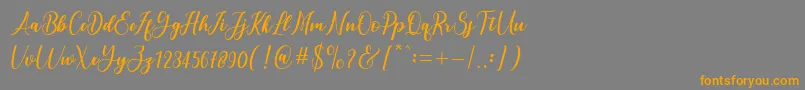フォントandayani – オレンジの文字は灰色の背景にあります。