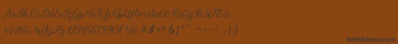 フォントAndella Script – 黒い文字が茶色の背景にあります