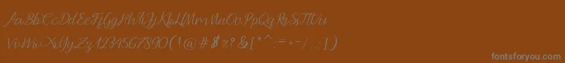 フォントAndella Script – 茶色の背景に灰色の文字