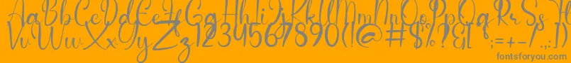 Anderella Demo-Schriftart – Graue Schriften auf orangefarbenem Hintergrund