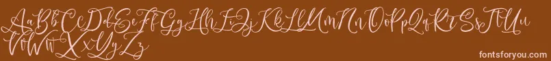 Andriani Script-fontti – vaaleanpunaiset fontit ruskealla taustalla