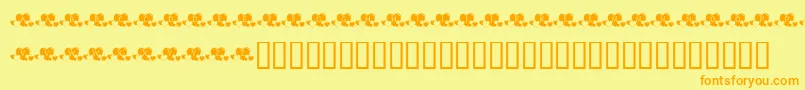 KrLotsOfHearts-Schriftart – Orangefarbene Schriften auf gelbem Hintergrund