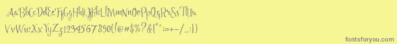 Angelia Script Free Demo Font – Gray Fonts on Yellow Background