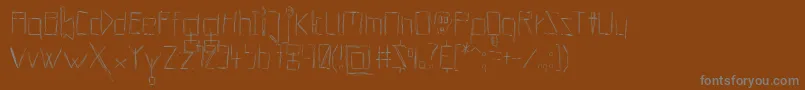 フォントHellsKittchenDevilGod – 茶色の背景に灰色の文字