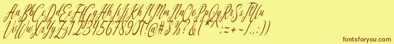 フォントAquilera Script – 茶色の文字が黄色の背景にあります。