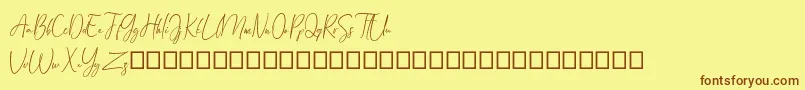 フォントArandalle Script Demo – 茶色の文字が黄色の背景にあります。