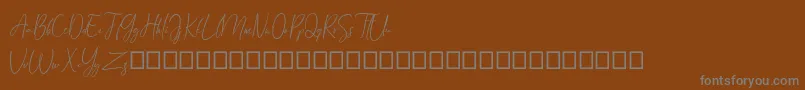 Шрифт Arandalle Script Demo – серые шрифты на коричневом фоне