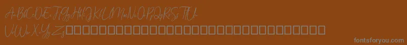 Czcionka Arandalle Script Demo – szare czcionki na brązowym tle