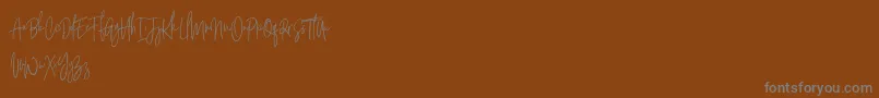 Czcionka Argents Free – szare czcionki na brązowym tle