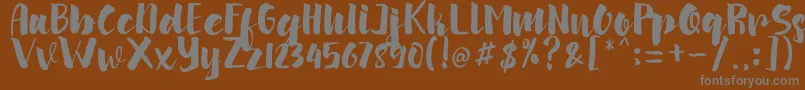 arinda-fontti – harmaat kirjasimet ruskealla taustalla