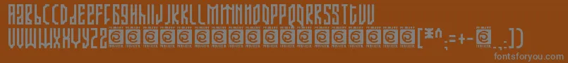 ARJUNKA Free-fontti – harmaat kirjasimet ruskealla taustalla