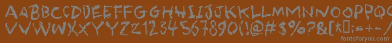 asqualt-fontti – harmaat kirjasimet ruskealla taustalla