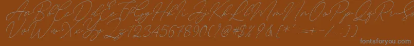 August Script Bold Free-Schriftart – Graue Schriften auf braunem Hintergrund
