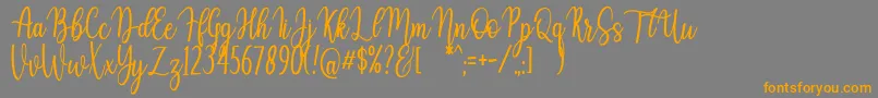 Auristela Script-fontti – oranssit fontit harmaalla taustalla