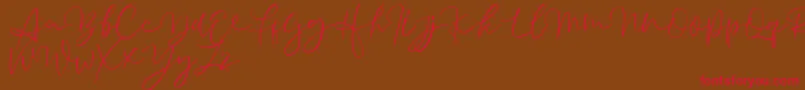 フォントAussiente Free Version – 赤い文字が茶色の背景にあります。