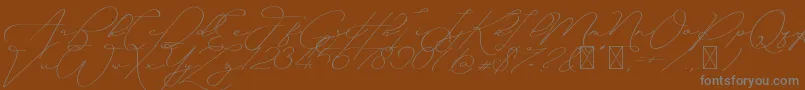 Ayudisha Free Version-Schriftart – Graue Schriften auf braunem Hintergrund