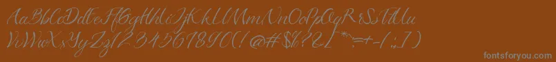 Azkadina Dafont-Schriftart – Graue Schriften auf braunem Hintergrund