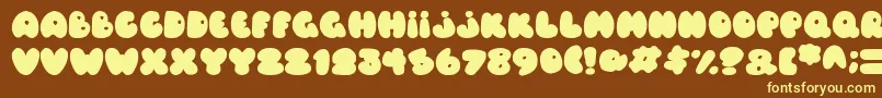 Balloons Italic-fontti – keltaiset fontit ruskealla taustalla