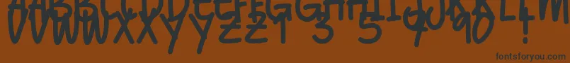 フォントBalltimore Caps – 黒い文字が茶色の背景にあります
