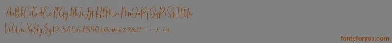 BasstonScript-Schriftart – Braune Schriften auf grauem Hintergrund