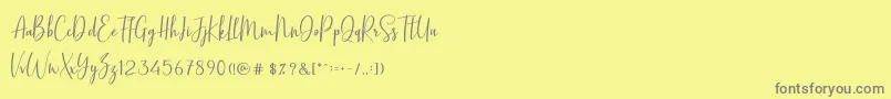 フォントBasstonScript – 黄色の背景に灰色の文字