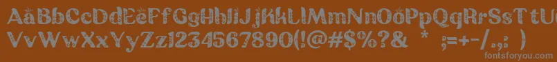 フォントBatik Ganasan – 茶色の背景に灰色の文字