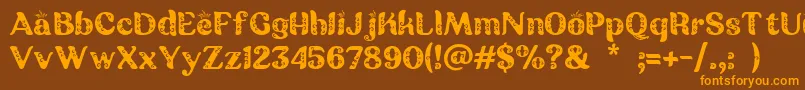 Czcionka Batik Ganasan – pomarańczowe czcionki na brązowym tle