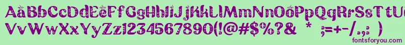 フォントBatik Ganasan – 緑の背景に紫のフォント