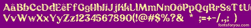 Czcionka Batik Ganasan – żółte czcionki na fioletowym tle