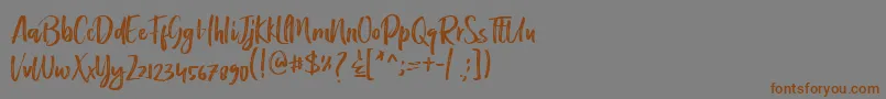 フォントBeatley – 茶色の文字が灰色の背景にあります。