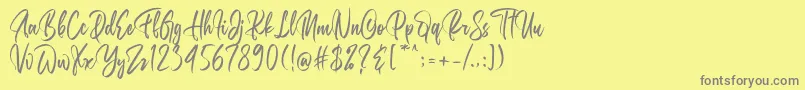 フォントBelgedes – 黄色の背景に灰色の文字